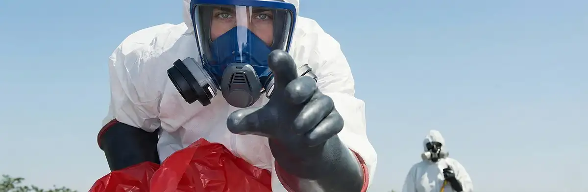 sewage clean up technician wearing protective gear handling biohazard materials in Atlanta, GA