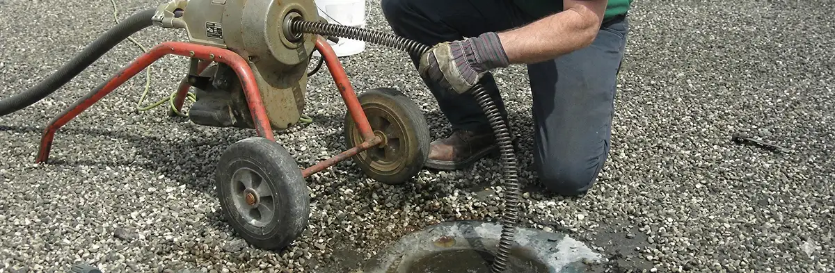 sewer rodding technician actively removing blockages from a sewer line in Atlanta, GA